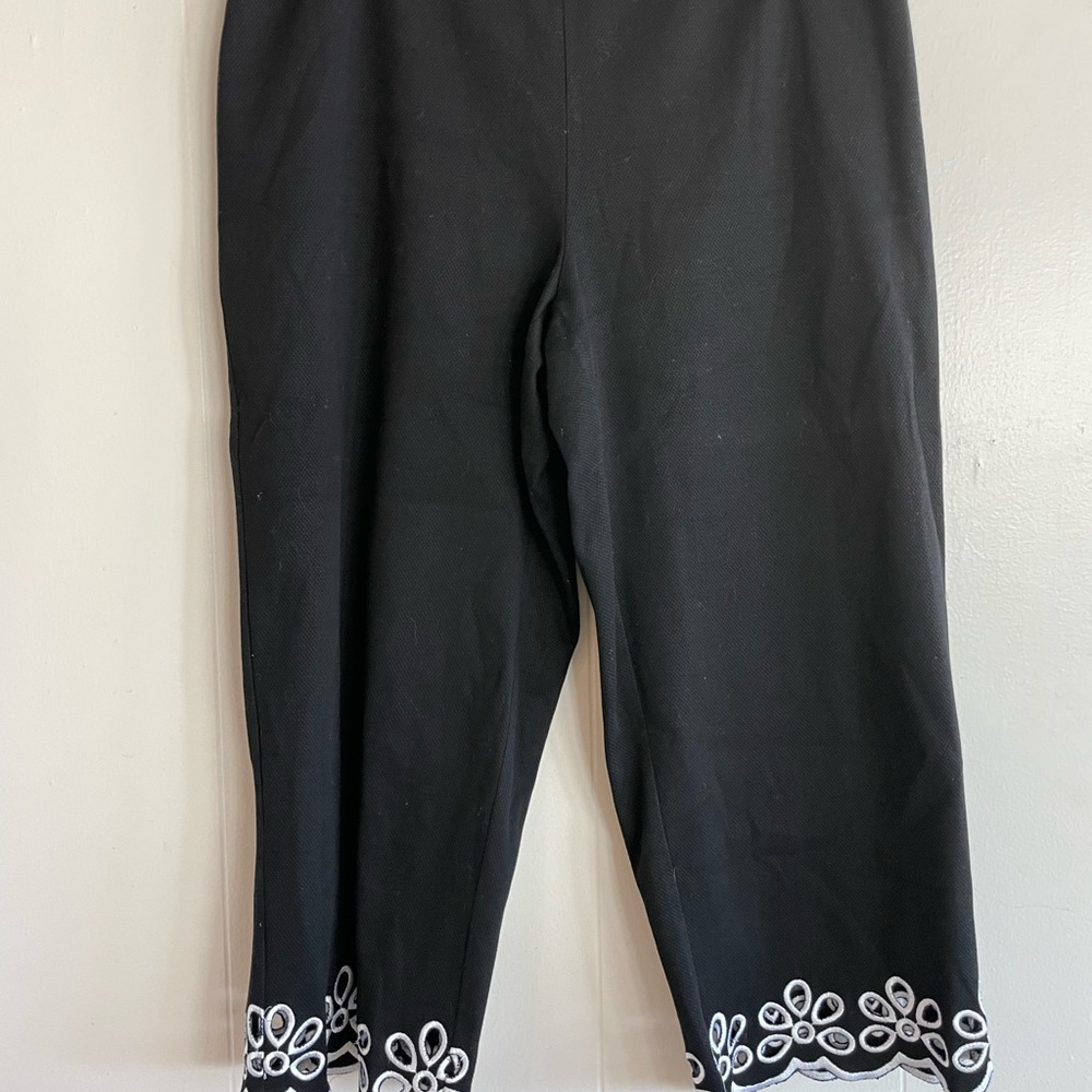 Black pedal pusher pants with white flower cut out embroidery. Size 16.